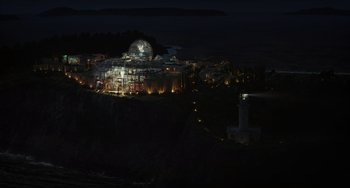 Movie still from “Glass Onion” (2022), directed by Rian Johnson – A night view of a city lit up at night; Extreme Wide shot, High angle