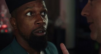 Movie still from “Glass Onion” (2022), directed by Rian Johnson – A person with a beard; Close Up shot, Over the shoulder angle