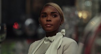 Movie still from “Glass Onion” (2022), directed by Rian Johnson – A woman in a white jacket and a white shirt; Close Up shot, Low angle