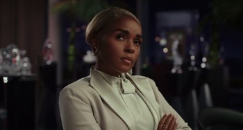 Movie still from “Glass Onion” (2022), directed by Rian Johnson – A person wearing a suit and tie; Close Up shot, Low angle