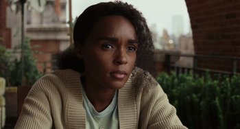 Movie still from “Glass Onion” (2022), directed by Rian Johnson – A person wearing a sweater; Close Up shot, Over the shoulder angle