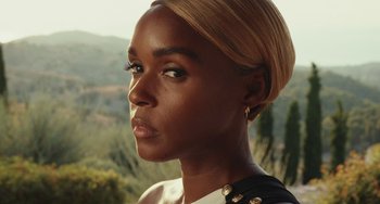 Movie still from “Glass Onion” (2022), directed by Rian Johnson – A person wearing a dress; Close Up shot, Over the shoulder angle