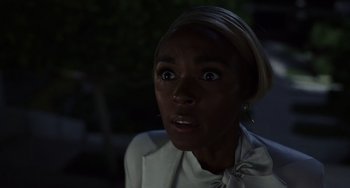 Movie still from “Glass Onion” (2022), directed by Rian Johnson – A person with a surprised look on their face; Close Up shot, Over the shoulder angle
