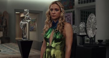 Movie still from “Glass Onion” (2022), directed by Rian Johnson – A woman in a green dress standing in a room; Medium shot, Low angle