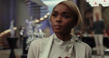 Movie still from “Glass Onion” (2022), directed by Rian Johnson – A person wearing a suit and tie; Close Up shot, Over the shoulder angle