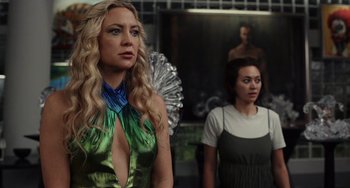 Movie still from “Glass Onion” (2022), directed by Rian Johnson – Two women are dressed up as fairies; Medium shot, Over the shoulder angle