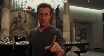 Movie still from “Glass Onion” (2022), directed by Rian Johnson – A man in a gray shirt is pointing his finger at the camera; Close Up shot, Low angle