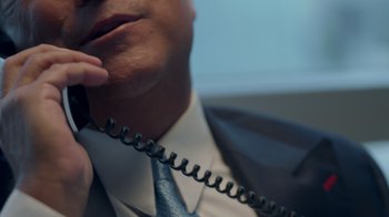Movie still from “God Forbid” (2022), directed by Billy Corben – A person talking on a phone; Extreme Close Up shot, High angle