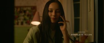 Movie still from “God Is a Bullet” (2023), directed by Nick Cassavetes – A woman is talking on a cell phone; Close Up shot, Over the shoulder angle