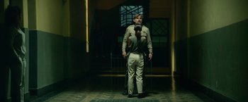 Movie still from “God Is a Bullet” (2023), directed by Nick Cassavetes – A man and a woman standing in a room; Wide shot, Low angle