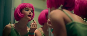 Movie still from “God Is a Bullet” (2023), directed by Nick Cassavetes – A woman with pink hair putting lipstick on in front of a mirror; Close Up shot, Over the shoulder angle