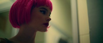 Movie still from “God Is a Bullet” (2023), directed by Nick Cassavetes – A person wearing a pink wig; Close Up shot, Over the shoulder angle