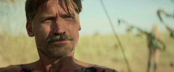 Movie still from “God Is a Bullet” (2023), directed by Nick Cassavetes – A person with a mustache; Close Up shot, Over the shoulder angle