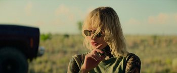 Movie still from “God Is a Bullet” (2023), directed by Nick Cassavetes – A woman with blonde hair wearing sunglasses and a t - shirt; Close Up shot, Over the shoulder angle