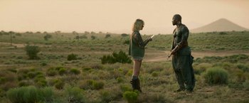 Movie still from “God Is a Bullet” (2023), directed by Nick Cassavetes – A woman and a man standing in the middle of a field; Wide shot, Over the shoulder angle