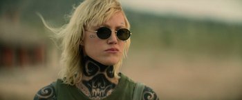 Movie still from “God Is a Bullet” (2023), directed by Nick Cassavetes – A woman with a skull tattoo on her neck; Close Up shot, Over the shoulder angle
