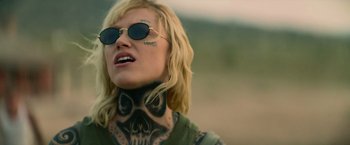 Movie still from “God Is a Bullet” (2023), directed by Nick Cassavetes – A woman with a skull tattoo on her neck; Close Up shot, Over the shoulder angle