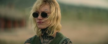 Movie still from “God Is a Bullet” (2023), directed by Nick Cassavetes – A woman with tattoos on her arms and face; Close Up shot, Over the shoulder angle