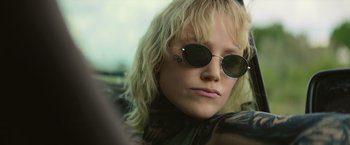 Movie still from “God Is a Bullet” (2023), directed by Nick Cassavetes – A person wearing sunglasses; Close Up shot, Low angle