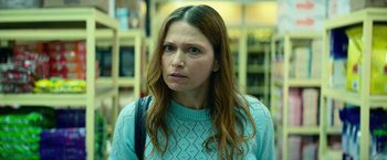 Movie still from “God Is a Bullet” (2023), directed by Nick Cassavetes – A person with long hair wearing a sweater; Close Up shot, Over the shoulder angle