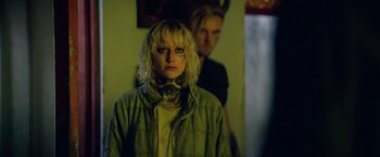 Movie still from “God Is a Bullet” (2023), directed by Nick Cassavetes – A woman standing next to a man in a room; Close Up shot, Over the shoulder angle