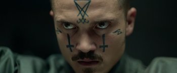 Movie still from “God Is a Bullet” (2023), directed by Nick Cassavetes – A man with tattoos on his head and face; Close Up shot, High angle