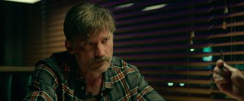 Movie still from “God Is a Bullet” (2023), directed by Nick Cassavetes – A person wearing a plaid shirt; Close Up shot, Over the shoulder angle