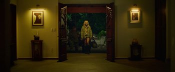 Movie still from “God Is a Bullet” (2023), directed by Nick Cassavetes – A woman standing in front of a door way; Wide shot, Low angle
