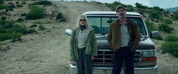 Movie still from “God Is a Bullet” (2023), directed by Nick Cassavetes – A man and a woman standing in front of a truck; Medium shot, Low angle