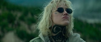 Movie still from “God Is a Bullet” (2023), directed by Nick Cassavetes – A woman with a tattoo on her neck and face; Close Up shot, Low angle