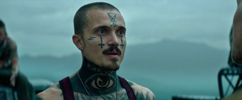 Movie still from “God Is a Bullet” (2023), directed by Nick Cassavetes – A man with tattoos on his face and neck; Close Up shot, Low angle