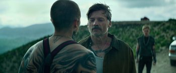 Movie still from “God Is a Bullet” (2023), directed by Nick Cassavetes – A man and a boy are standing in a field; Close Up shot, Over the shoulder angle