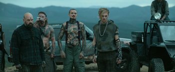 Movie still from “God Is a Bullet” (2023), directed by Nick Cassavetes – A group of men standing next to each other on top of a hill; Medium shot, Low angle