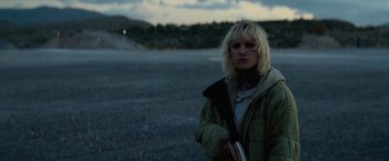 Movie still from “God Is a Bullet” (2023), directed by Nick Cassavetes – A woman standing in the middle of a road; Medium shot, Low angle