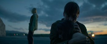 Movie still from “God Is a Bullet” (2023), directed by Nick Cassavetes – A man and a woman hugging on the beach; Medium shot, Low angle