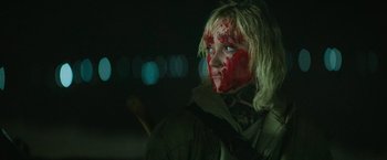 Movie still from “God Is a Bullet” (2023), directed by Nick Cassavetes – A young woman with red paint on her face; Close Up shot, Over the shoulder angle