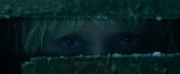 Movie still from “God Is a Bullet” (2023), directed by Nick Cassavetes – A woman's eyes are seen through a fence; Extreme Close Up shot, Overhead angle