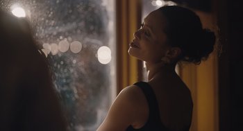 A beautiful woman sitting in front of a window