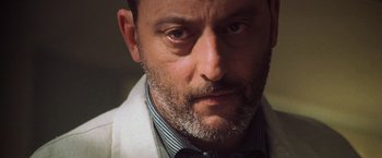 Movie still from “Godzilla” (1998), directed by Roland Emmerich – A person wearing a lab coat; Close Up shot, Low angle