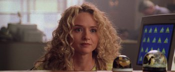 Movie still from “Godzilla” (1998), directed by Roland Emmerich – A person sitting at a table; Close Up shot, Over the shoulder angle