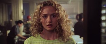 Movie still from “Godzilla” (1998), directed by Roland Emmerich – A person with curly blonde hair; Close Up shot, Over the shoulder angle