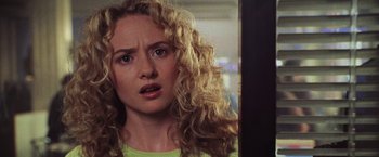 Movie still from “Godzilla” (1998), directed by Roland Emmerich – A person with curly blonde hair; Close Up shot, Over the shoulder angle