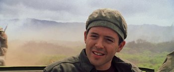 Movie still from “Godzilla” (1998), directed by Roland Emmerich – A man wearing a hat smiling for the camera; Close Up shot, Low angle