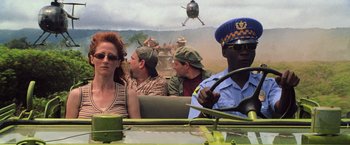 Movie still from “Godzilla” (1998), directed by Roland Emmerich – A woman sitting in the driver's seat of an army vehicle; Medium shot, Over the shoulder angle