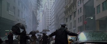 Movie still from “Godzilla” (1998), directed by Roland Emmerich – A group of people walking down a street with umbrellas; Extreme Wide shot, Low angle