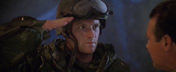 Movie still from “Godzilla” (1998), directed by Roland Emmerich – A man wearing a helmet with goggles on his head; Close Up shot, Low angle