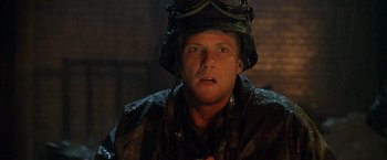 Movie still from “Godzilla” (1998), directed by Roland Emmerich – A man wearing a helmet and a camouflage jacket; Close Up shot, Low angle