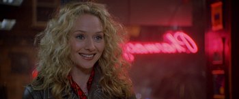 Movie still from “Godzilla” (1998), directed by Roland Emmerich – A person with curly blonde hair; Close Up shot, Over the shoulder angle