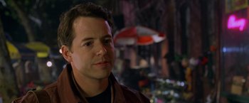 Movie still from “Godzilla” (1998), directed by Roland Emmerich – A person wearing a brown jacket; Close Up shot, Over the shoulder angle