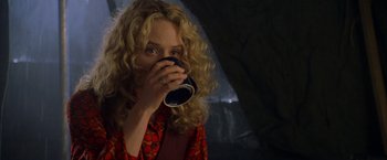 Movie still from “Godzilla” (1998), directed by Roland Emmerich – A woman drinking a cup of coffee from a mug; Medium shot, Low angle